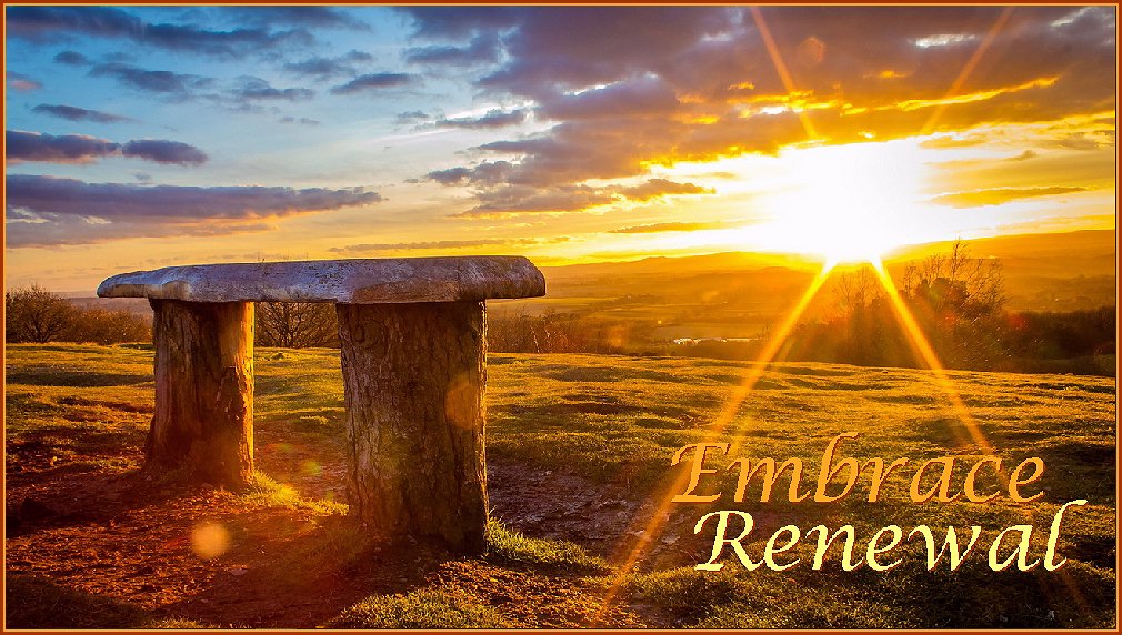 A rustic hillside bench with sunrise over the valley